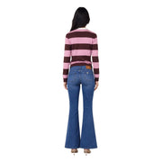 Blue denim flare jeans with classic five-pocket design and brown leather brand patch on back waistband shown from back