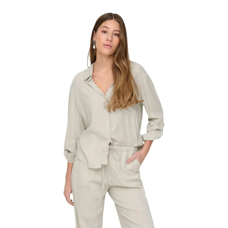 Jacqueline De Yong women grey linen v neck loose shirt featuring a soft light gray button-up design with rolled sleeves