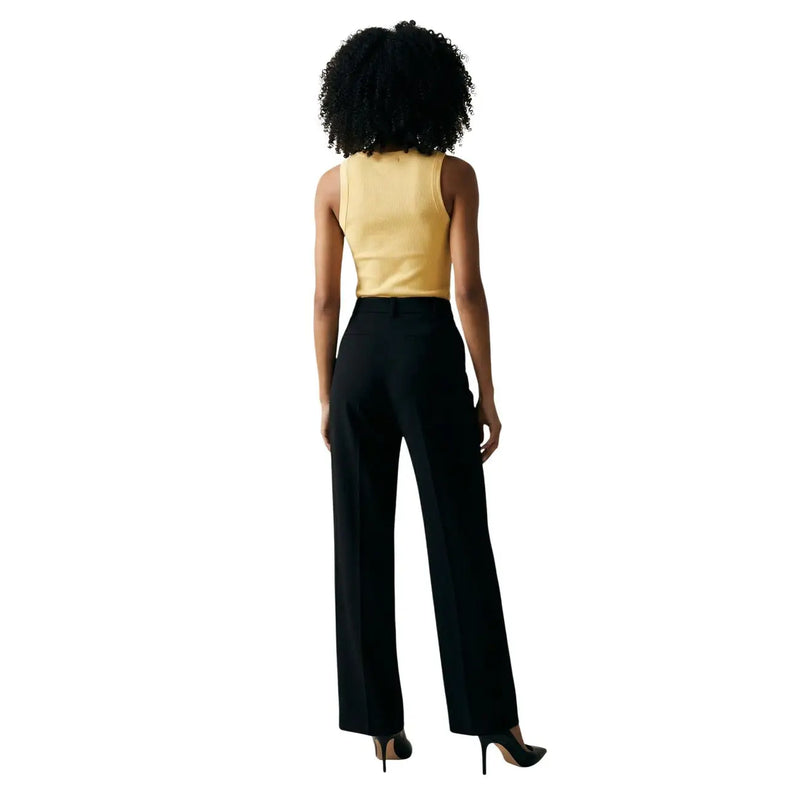 Black high-waisted wide-leg trousers with a sleek tailored fit paired with jacqueline de yong yellow tank top v neck buttons