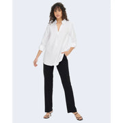 White oversized button-down shirt with rolled sleeves and v-neckline paired with jacqueline de yong black polyester trousers