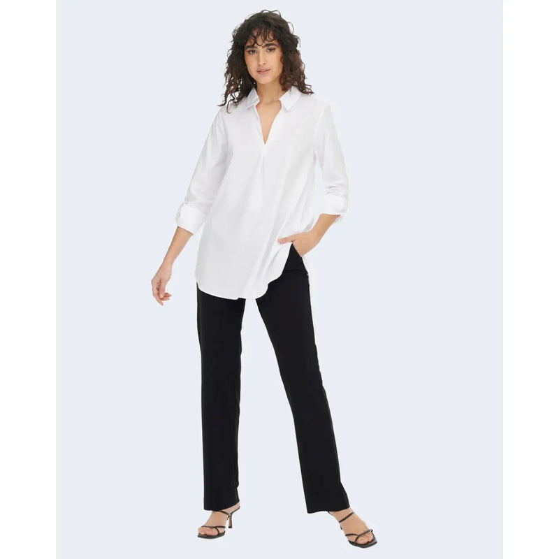 White oversized button-down shirt with rolled sleeves and v-neckline paired with jacqueline de yong black polyester trousers