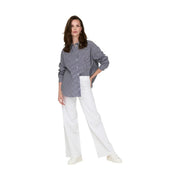 A woman wears Jacqueline de Yong white cotton trousers size 30 with a navy and white striped button-up shirt