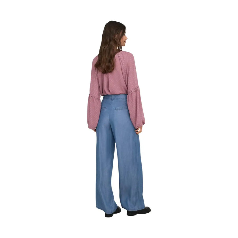 A woman wearing jacqueline de yong women wide leg blue lyocell trousers with a soft pink blouse and flared sleeves