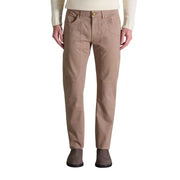 Men’s slim-fit tan trousers with button closure paired with dark brown suede ankle boots