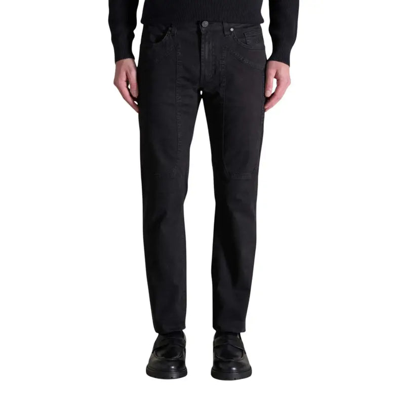 Men’s black denim straight-fit jeans with button-fly closure paired with black loafers