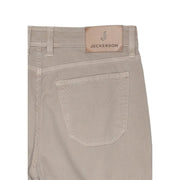 Beige corduroy jeckerson men trousers with tan leather brand patch on waistband made from cotton blend pique