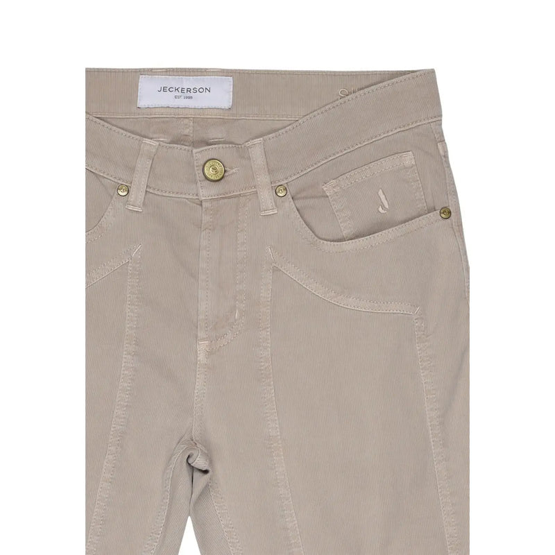 Beige corduroy jeans with subtle ribbed texture gold tone hardware and jeckerson label at waistband cotton blend pique