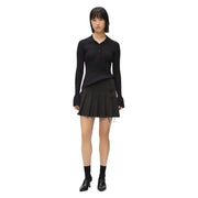 Black ribbed knit long-sleeve polo shirt with buttoned collar and flared cuffs paired with Karl Lagerfeld Jeans black zip skirt for women