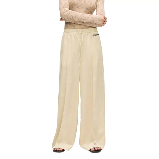 Cream-colored wide-leg satin trousers by Karl Lagerfeld Jeans with soft flowing fabric and subtle waistband branding