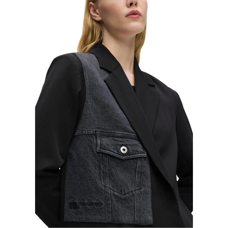 Black denim vest with silver toned button and front pocket worn over Karl Lagerfeld Jeans women’s black blazer with lapel collar