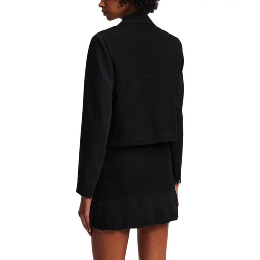 Woman wearing a black cropped blazer and mini skirt from Karl Lagerfeld Jeans for fall winter