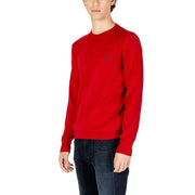 A vibrant red long-sleeved knitted sweater with a crewneck and small embroidered logo on the left chest