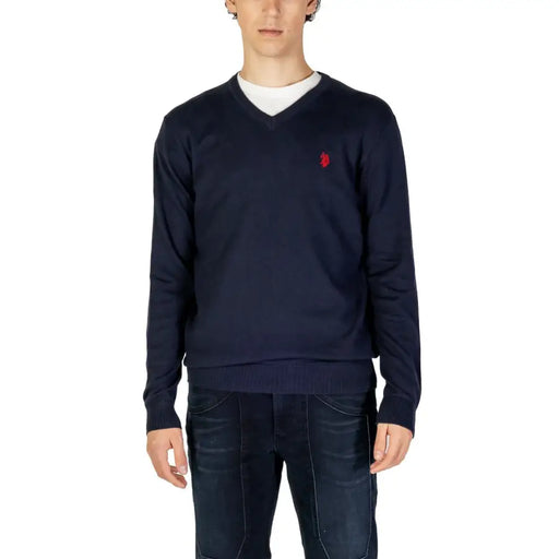 Navy blue knitted v-neck sweater with small red embroidered logo on left chest from knitted clothing collection