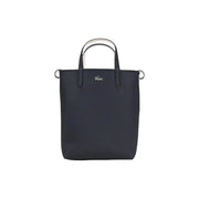 Lacoste black zip handbag tote with textured fabric and contrasting white handles featuring shoulder strap and inner pouch