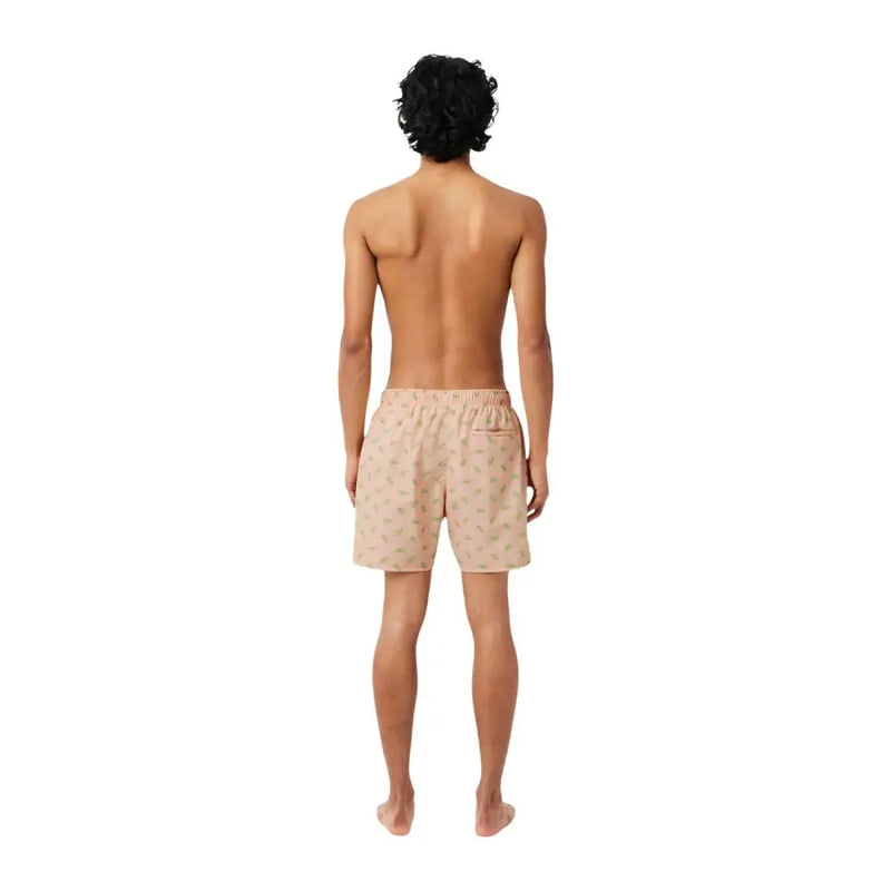 Beige Lacoste Herren-Badeshorts aus Polyester mit rosa Print, dezentem grünem Blattmuster und elastischem Bund