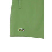 Green Lacoste men swimwear shorts featuring a classic embroidered crocodile logo on the lower leg