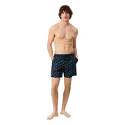 Dark blue Lacoste men swim trunks with a repeating pattern of small light green palm trees for beachwear