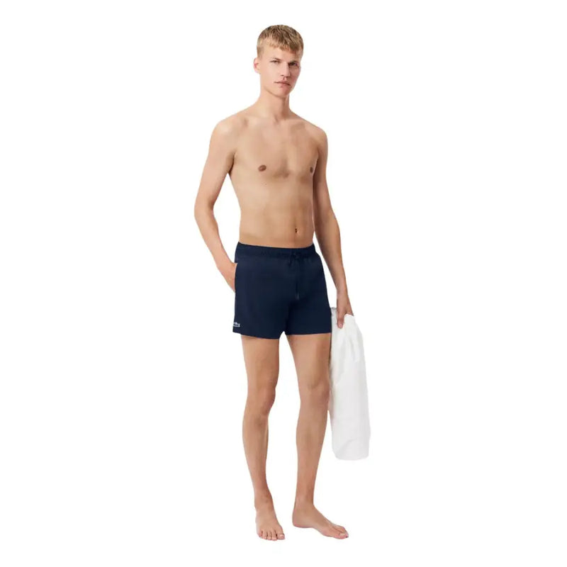 Navy blue Lacoste men swimwear swim trunks featuring a small logo on the left leg for comfortable water activities
