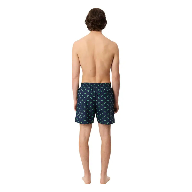 Dark blue Lacoste men swimwear swim trunks with a subtle light green palm tree pattern for beach use