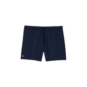 Navy blue Lacoste men swim trunks with subtle textured fabric and green crocodile logo on the lower left leg