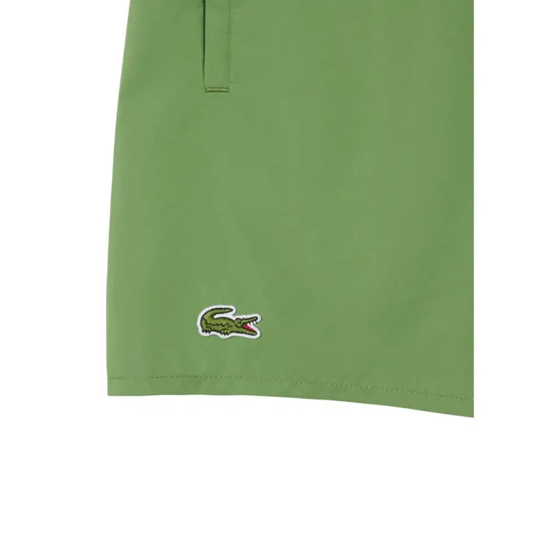 Green Lacoste men swimwear shorts with classic embroidered crocodile logo on lower leg for swimwear use