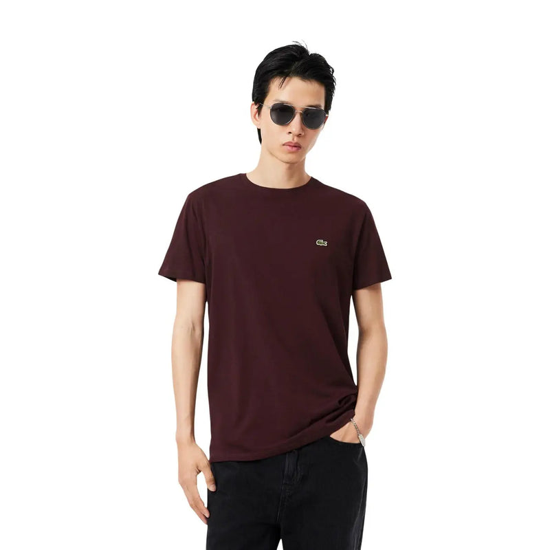 A maroon Lacoste mens short-sleeved cotton t-shirt with an embroidered crocodile logo on the left chest
