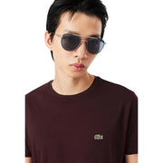 Silver-framed aviator sunglasses with dark gray lenses paired with lacoste mens bordeaux cotton t shirt