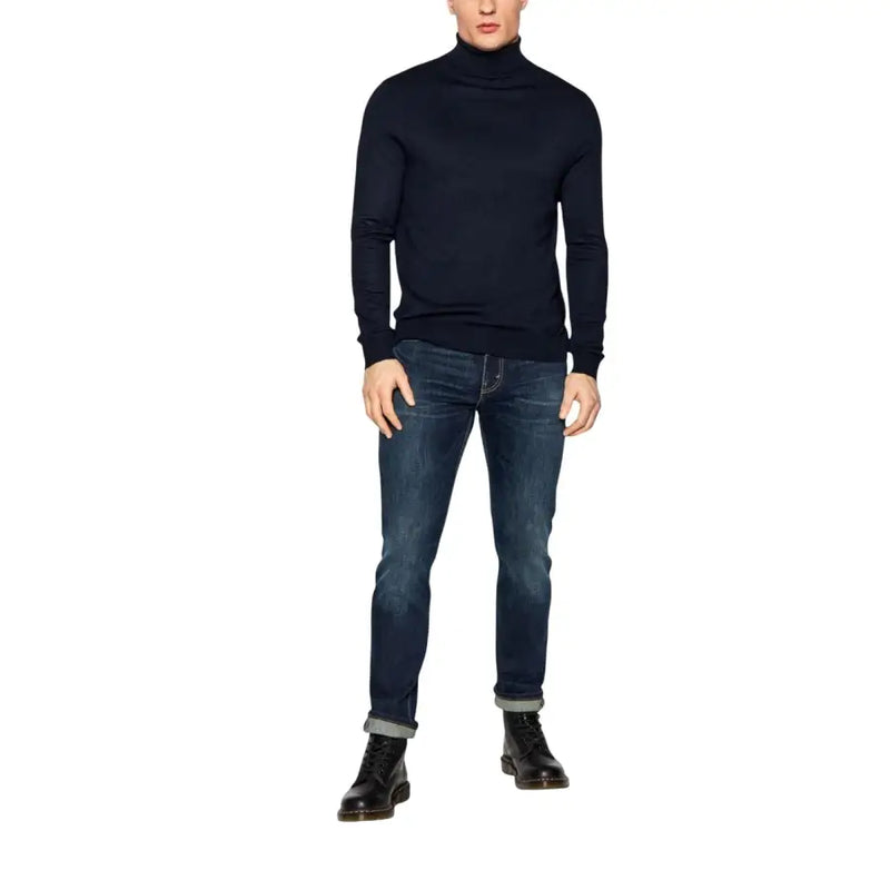 Dark blue slim-fit jeans with rolled cuffs and black turtleneck sweater, classic style
