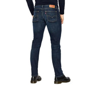 Back view of levi’s men jeans blue cotton stretch regular fit in dark indigo denim with five pockets and red leather patch