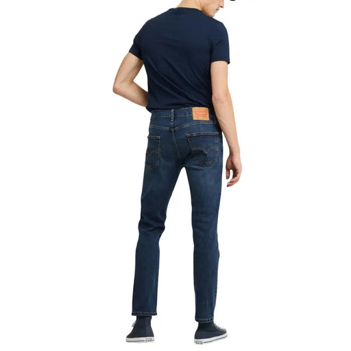 Dark blue slim fit jeans with a red levi’s patch on the back pocket.
