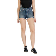 Woman wearing Levi’s blue cotton fall winter shorts with a black ribbed top and black sneakers