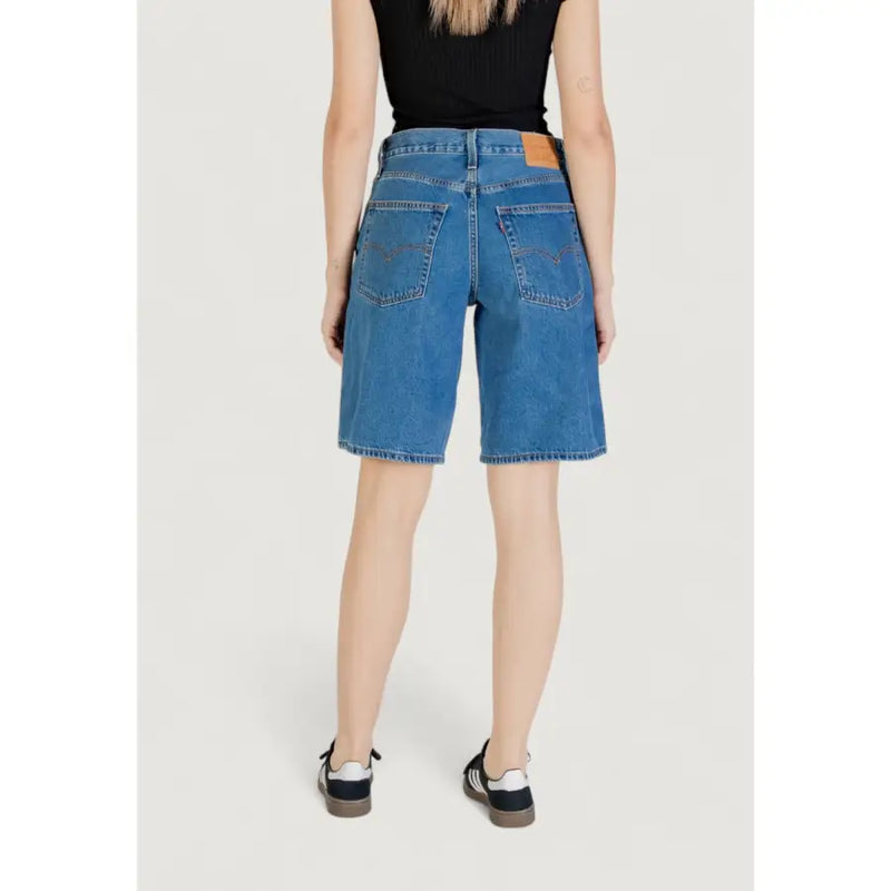 Back side of levis women blue cotton denim shorts featuring classic pocket design and brown leather brand patch