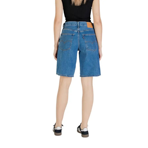 Women’s blue denim knee-length shorts with leather patch on back waistband for Levis product
