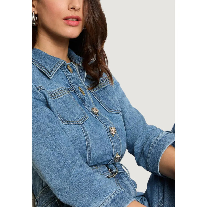 Light blue belted jumpsuit with pockets and three quarter sleeves paired with a blue denim jacket with gold buttons and collar