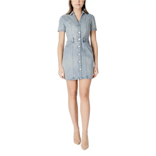 Light blue cotton button front dress with v neck, short sleeves, fitted waistband, and pockets in light-wash denim
