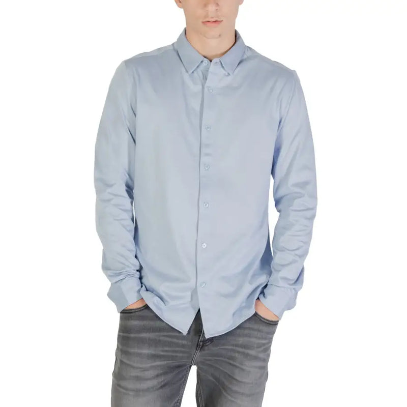 Light blue long sleeved shirt with classic collar and neatly pressed fabric ideal for formal or business wear