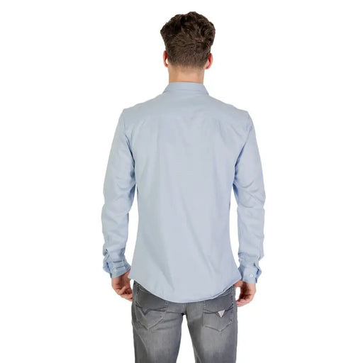 Light blue long sleeved dress shirt with classic collar and buttoned cuffs made of soft breathable fabric