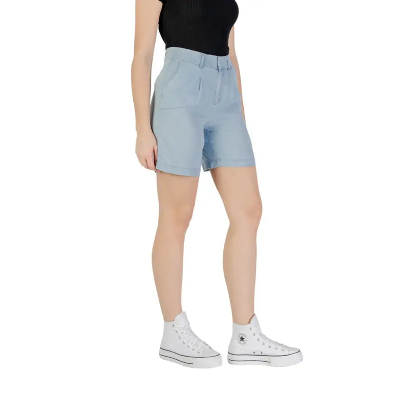 Light blue denim high-waist shorts with folded cuffs, front zip, and pockets for women
