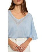 Light blue short sleeve v-neck knit top for women featuring delicate lace detailing along neckline and sleeves