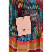 Light blue sleeveless polyester tank top for women with a pink twinset milano tag on a colorful pleated dress