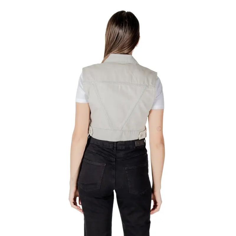 A light gray denim vest with a collar and buttoned waistband made from durable denim material