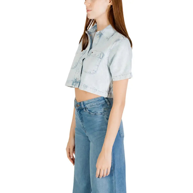 Light wash denim cropped shirt with short sleeves paired with wide-leg jeans for women