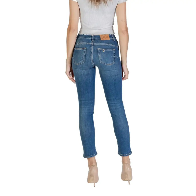 Women’s light blue skinny jeans with a brown leather patch on the back waistband