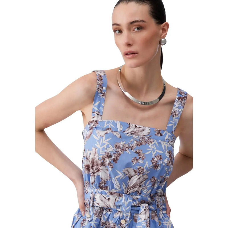 A woman wearing a Liu Jo women blue floral cotton sleeveless dress with thin straps and a matching waist belt
