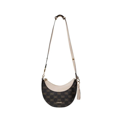 Monogrammed brown crescent-shaped shoulder bag with tassel charm and zip closure