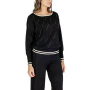 Women’s black long-sleeved knit sweater with white stripes and metallic accents