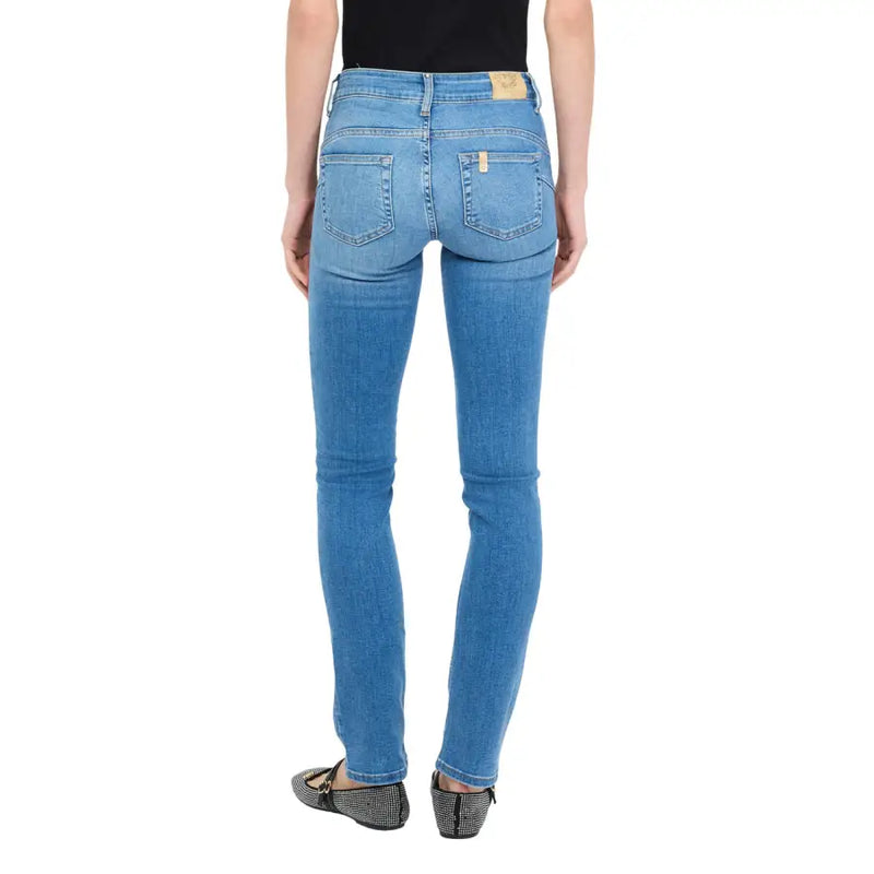Blue denim jeans with slim fit and subtle fading showing classic back pockets and a light brown leather patch