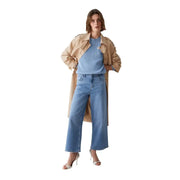 A woman wearing Liu Jo women’s blue cotton elastane spring summer jeans paired with a beige trench coat and light blue sweater