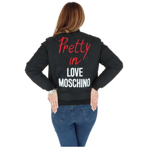 Back side of a love moschino blue printed women’s bomber jacket with black fabric and red and white embroidered text