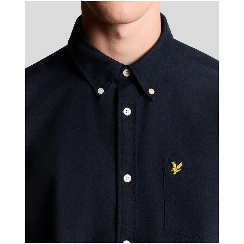 Navy blue lyle & scott long sleeve cotton shirt with white buttons and yellow embroidered bird logo on chest pocket